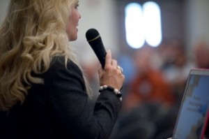 Michele with microphone talking to farmers